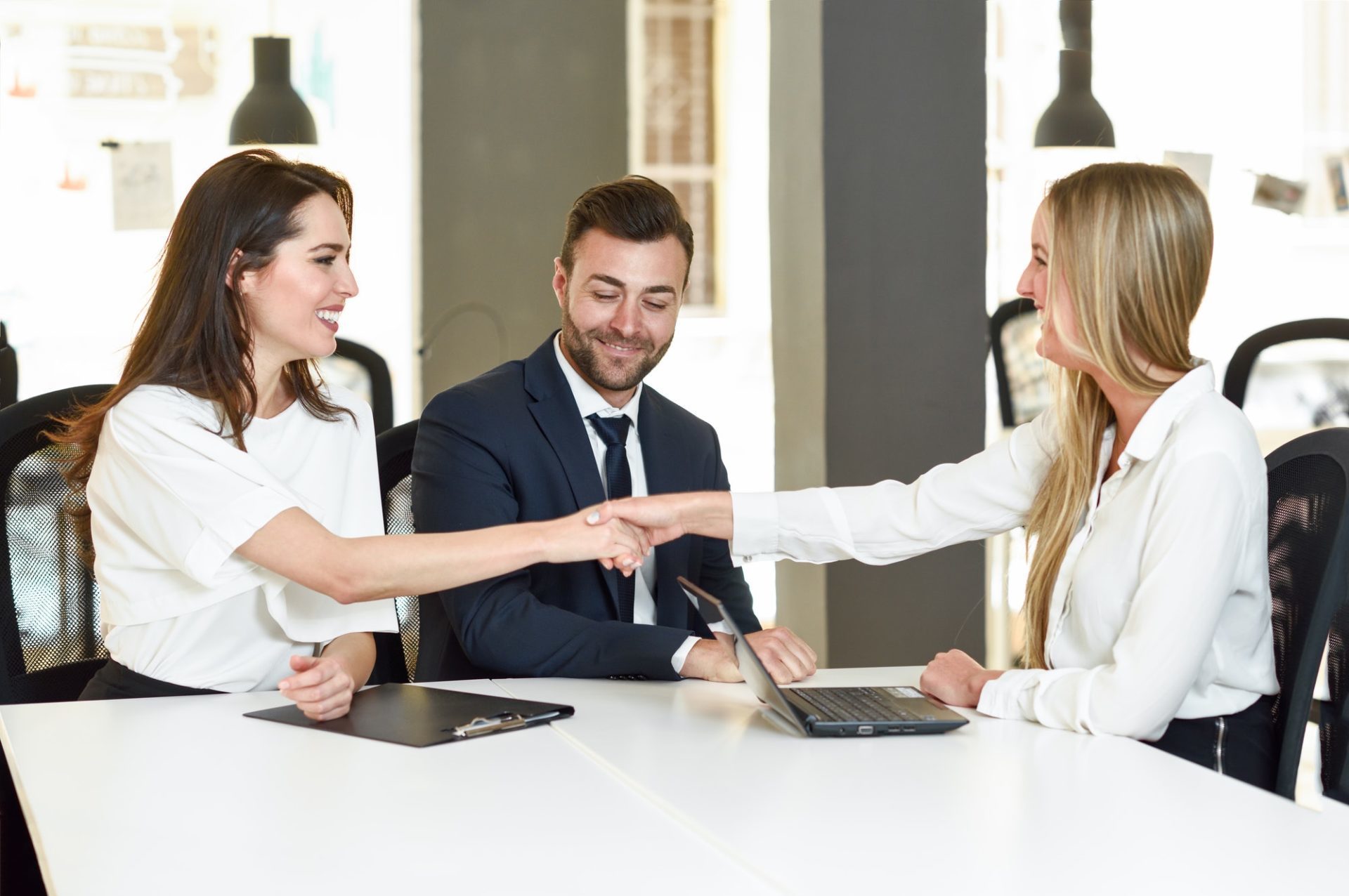 Couple shaking hands with an insurance agent